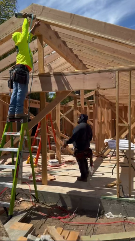 Crew framing roof rafters on a new residential build